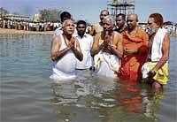 Invoking Blessings: Chief Minister B S Yeddyurappa taking a holy dip at Triveni Sangama in T Narasipur taluk on Saturday, on the occasion of Poorna Kumbh Mela. DH Photo
