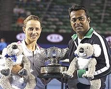 Cara Black of Zimbabwe and Leander Paes of India hold the trophy after beating Ekaterina Makarova of Russia and Jaroslav Levinsky of Czech Republic to win the Mixed doubles final match at the Australian Open tennis championship in Melbourne on Sunday. AP