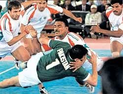 Tough catch: India's Prabin Gonewale (centre) tries to catch Pakistan's Abdul Mukhatar in a kabbadi match on Monday. AP