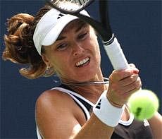 In this Aug. 28, 2007, file photo, Martina Hingis returns a volley to Mathilde Johansson of France at the US Open tennis tournament in New York. AP