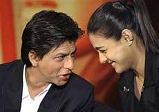 Shah Rukh Khan and Kajol Devgan talk to one another during a press conference as a trailer for their film 'My Name is Khan' is shown to an audience at a central London hotel, on Wednesday. AP