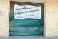Paddy purchase centre locked by APMC officials as no farmers come for purchasing paddy there.  DH Photo