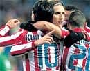 Jubilant : Atletico's Diego Forlan (centre) celebrates his goal with team-mates in their victory over Racing Santander in the first-leg of the Kings Cup semifinal on Friday. AP