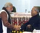 Cold war? Finance Minister Pranab Mukherjee shakes hands with Gujarat Chief Minister Narendra Modi during the Conference of Chief Ministers on Prices of Essential Commodities in New Delhi on Saturday. PTI