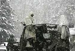 A vehicle carrying members of the Indian Army emergency rescue team is seen on way to Gulmarg, via Tangmarg, about 41 km northwest of Srinagar on Monday. A massive avalanche plowed into an Indian army training centre at a ski resort town. AP Photo