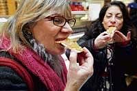 carnal food hunt: Dana Jacobi (left) samples salmon with flying fish roe during a stop at Russ & Daughters on the Lower East Side of Manhattan. The deli was part of a tour focused on foods thought to be aphrodisiacs, led by Meryl S Rosofsky (right). nyt