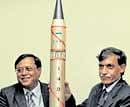 Chief military scientist V K  Saraswat, left, and Programme Director AGNI missile Avinash Chander pose with a model of the Agni missile in New Delhi on Wednesday. AP