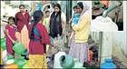 Women waiting with pitchers for collecting water at Yasin Nagar. Inset: Control valve fitted to the BWSSB water line.