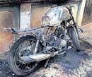 A motorcycle that was torched by miscreants on Thursday night at Sunkadakatte near Magadi in Bangalore. DH Photo