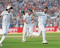 Flying sikh: Harbhajan Singh (right) cant hide his joy after dismissing Jean-Paul Duminy on the first day of the second Test at Kolkata on Sunday . AFP