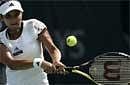 Sania Mirza returns the ball to Spain's Anabel Medina Garrigues during the second day of the Emirates Dubai WTA Tennis Championships in Dubai on Monday. AP