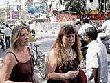 Life goes on: Foreign tourists walk near the explosion-hit German Bakery in Pune on Monday. PTI