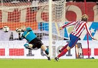On target: Atletico Madrids Diego Forlan scores the opening goal past Barcelonas goalkeeper Victor Valdes during their  Spanish League fixture on  Sunday. AFP