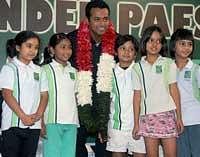 Indian tennis star Leander Pace pose for a photograph with children at a felicitation function, after winning the 11th grand slam title at the Australian Open 2010, in Kolkata on Monday. PTI