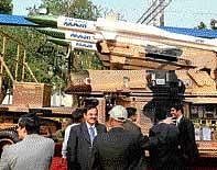 Visitors in front of DRDOs Akash medium range surface-to-air missile system at the DefExpo-India 2010 in New Delhi on Tuesday. AP