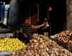 An Indian customer buys vegetables at a wholesale market in New Delhi on Wednesday. AFP