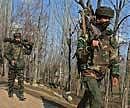 Army personnel at the scene of a gunbattle where two militants of Jaish-e-Mohammad (JeM) outfit holed up inside a house in Chadoosa, 60 kms North of Srinagar, on Wednesday. Both the militants were killed in the day-long encounter. PTI