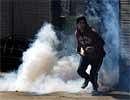 A Kashmiri protestor prepares to throw back a tear gas shell fired by Indian police during a one-day strike in Srinagar on Saturday. AFP