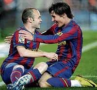 well done, mate: Barcelona's Andres Iniesta (left) celebrates with team-mate Bojan Krkic after scoring against Racing Santander in the Spanish League on Saturday. AP