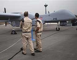 Israeli soldiers stand next to an unmanned plane in the Tel Nof base, in central Israel on Sunday. AP