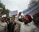 BJP activists protest against the beheading of Sikhs by Pakistan Talibans, in New Delhi on Monday. PTI