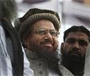 In this Feb. 5, 2010 photo, Hafiz Saeed, the leader of a banned Islamic group Jamaat-ud-Dawa is surrounded by his supporters during an anti-Indian rally to show solidarity with Indian Kashmiris, in Lahore, Pakistan. AP
