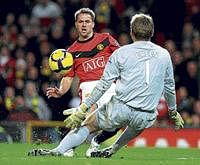 deft touch Manchester Uniteds Michael Owen (left) scores past West Ham United goalkeeper Robert Green during their English Premier League clash on Tuesday. afp