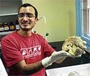 Research scholar Arjun Ramachandran displaying a human brain at the IISc Open Day on Friday. DH Photo
