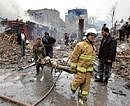 GORY END: Afghans carry a victim from a blast site in Kabul on Friday. Reuters