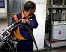 An Indian worker fills fuel in a motorcycle at a petrol station in New Delhi on February 26, 2010. AFP