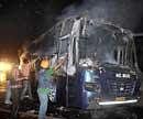 A bus set on fire by Dera Sacha Sauda followers at Goniana Mandi in Bathinda on Saturday. PTI