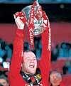 Manchester Uniteds Wayne Rooney celebrates with the League Cup. Reuters