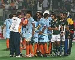 Indian hockey team coach Jose Brasa (L) greets Indian players as Pakistani and Indian players greet each other during the Hero Honda FIH Word Cup hockey tournament at Major Dhyanchand National Stadium in New Delhi on Sunday. Indian won the match by 4-1.PTI