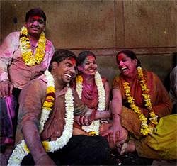 Devotees smeared with color celebrate Holi, the Hindu festival of color, at the Banke Bihari temple in Vrindavan, Sunday.  Vrindavan is famous for Holi celebration, where according to legend, Hindu god Krishna played Holi with his consort Radha. AP