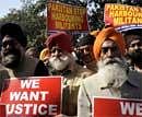 Members of the Shiromani Akali Dal (Badal) hold placards during a protest against the killing of a Sikh in Pakistan, near the Pakistan Embassy in New Delhi on February 23, 2010. AFP