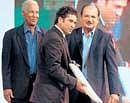 Sachin Tendulkar (centre) is presented with an autographed bat as West Indian great Garry Sobers (left) and former India captain Ajit Wadekar look on. PTI
