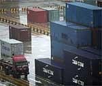 A truck carrying a container runs Yangshan deep-water port Friday, March 5, 2010 in Shanghai, China. AP