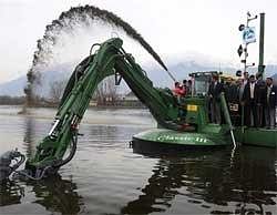 Chief Minister Omar Abdullah observing the functioning of state-of-the-art machine imported from Finland for deweeding and dredging in Dal Lake in Srinagar on Saturday. PTI