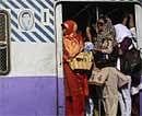 Women are seen traveling in a local train in Mumbai, India on Monday, March 8, 2010. AP