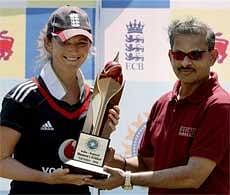 England's women's cricket team captain Charlotte Edwards collects the India - England T20 Series Trophy from Lalchand Rajput beating India in the third and final T20 match at the BKC MCA Cricket ground in Mumbai on Monday. PTI