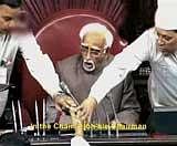 A TV grab shows one of the protesting MPs trying to snatch the copies of Women's Reservation Bill from Rajya Sabha Chairman Hamid Ansari to prevent its tabling in House in New Delhi on Monday. PTI / Courtesy Rajya Sabha