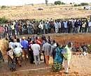 Natives of Dogo Nahawa village gather at the scene of a mass burial of their kinsmen killed during a religious crisis in the village of Dogo Nahawa, south of Jos on Monday. AFP