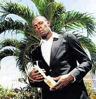 Unstoppable:  Usain Bolt poses with the World Sportsman of the Year award in Jamaica on Wednesday. AFP