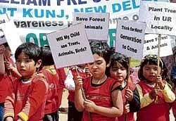 Schoolchildren hold placards as they take part in a rally to protest against rampant pollution near the India Gate in New Delhi on Wednesday. AFP