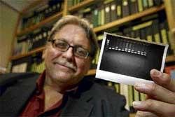 Bottling Up Genes: Dr James Lupski holds a printout of his decoded genome in his office in Houston, Texas. Lupski, who suffers with a nerve disease, had his whole genome decoded. NYT