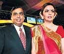 'All is Wealth: Industrialist Mukesh Ambani poses with wife Neeta Ambani at an awards ceremony in Mumbai on Wednesday. AFP