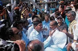 Deputy Commissioner V Ponnuraj trying to convince fishermen at the estuary in Mangalore on Friday. DH photo