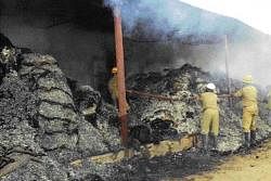 Cotton bales reduced to ashes in a fire at a  cotton factory in Ranebennur on Thursday night. DH photo