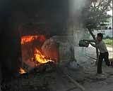 People try to douse fire after a shop was set on fire during the communal riots in Bareilly on Friday. PTI
