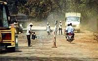 Patched Up: Repair works of the NH 4A which connects  North Karnataka and Goa being undertaken. DH Photo